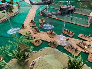 A picture containing cake, table, green, sitting Description automatically generated