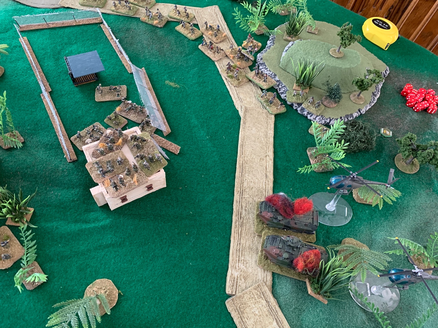 A picture containing table, indoor, cake, sitting

Description automatically generated